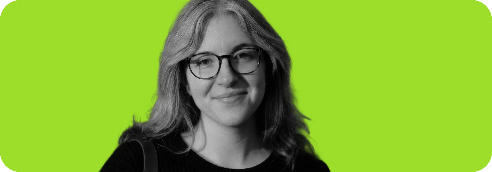 Portrait photo of Eleonora Selle smiling, in black and white on a green background